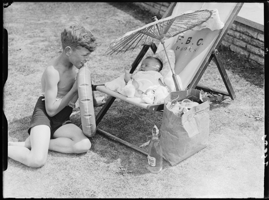 Boy watching a baby in a deckchair, 6 August 1937, Harold Tomlin Daily Herald Archive, National Media Museum Collection / SSPL