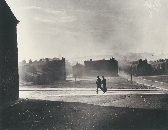 Two figures walk by cleared blitz site, Liverpool, 21 November 1949, White, Daily Herald Archive, National Media Museum Collection / SSPL