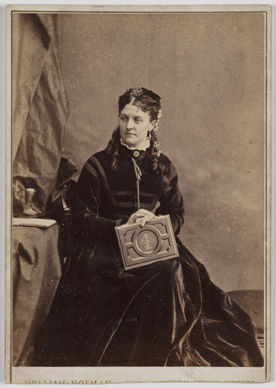 Woman holding a photograph album, c. 1880, William Notman © National Media Museum / SSPL. Creative Commons BY-NC-SA