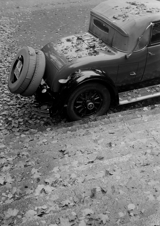 Rear of Buick car and stone steps covered in fallen leaves, Zoltan Glass © National Media Museum, Bradford / SSPL. Creative Commons BY-NC-SA