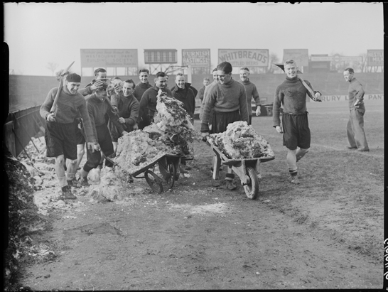 Fulham footballers clear snow from their pitch before Cup tie with Bury, 1939, Harold Tomlin © Daily Herald / National Media Museum, Bradford / SSPL