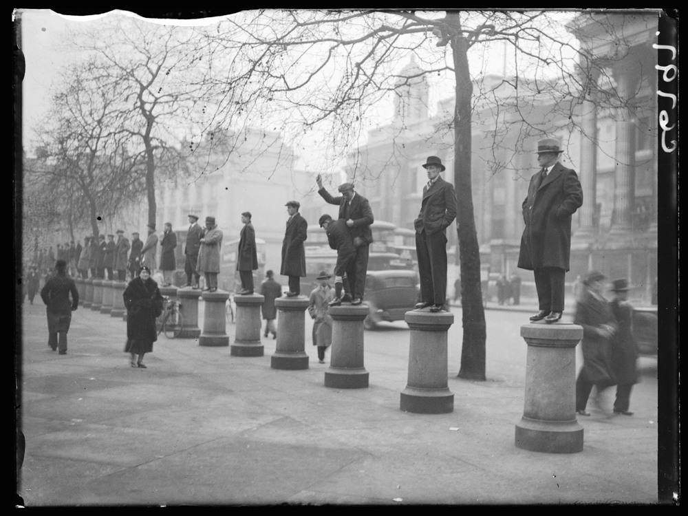 Men standing on bollards to watch a demonstration, 4 March 1934. Edward George Malindine / Daily Herald Archive / National Science and Media Museum Collection / SSPL