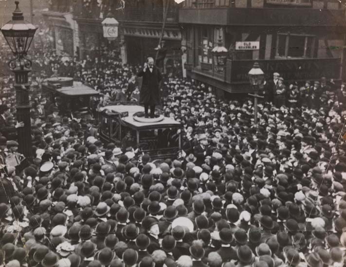 Churchill stood on top of a car addressing a large crowd in Manchester