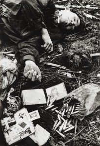 Dead North Vietnamese Soldier and His Plundered Belongings, Hue by Don McCullin