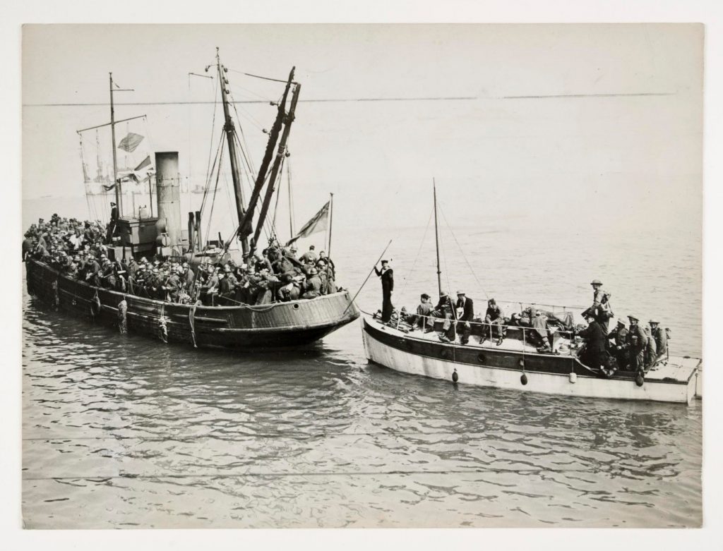 A photograph of two boats full of troops arriving in England from Dunkirk