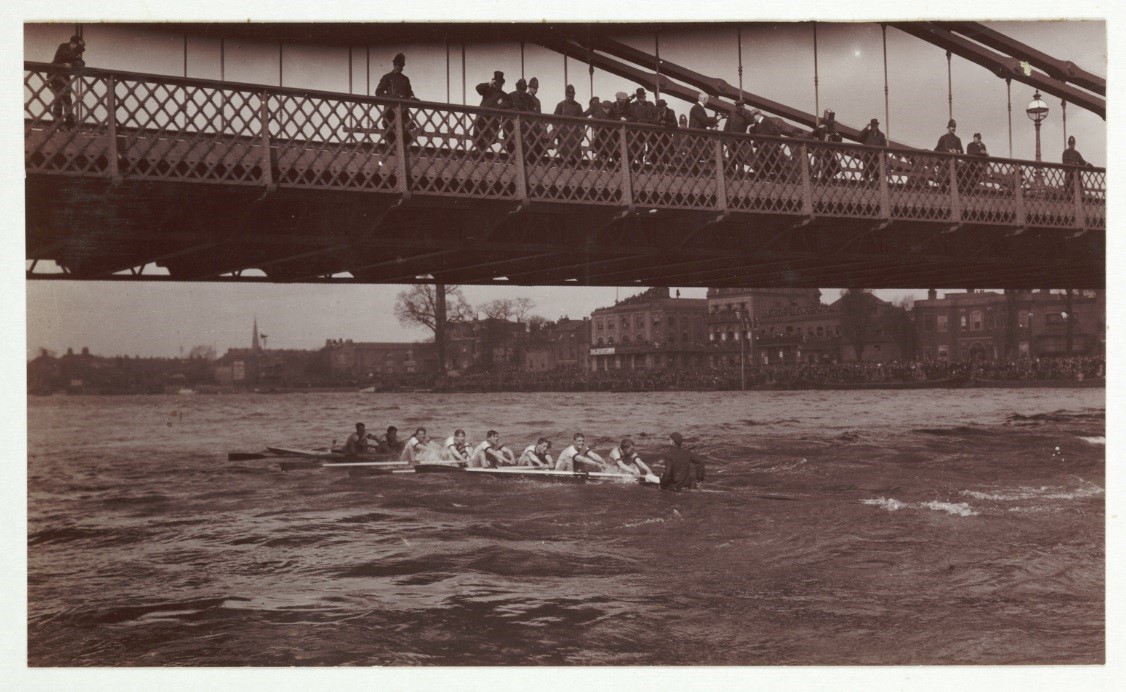Spectators filming the Boat Race from a bridge