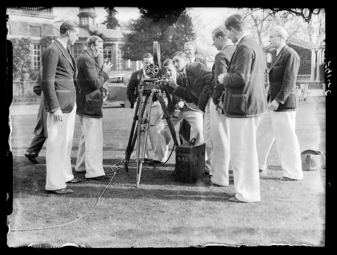 Oxford crew examining a newsreel camera 