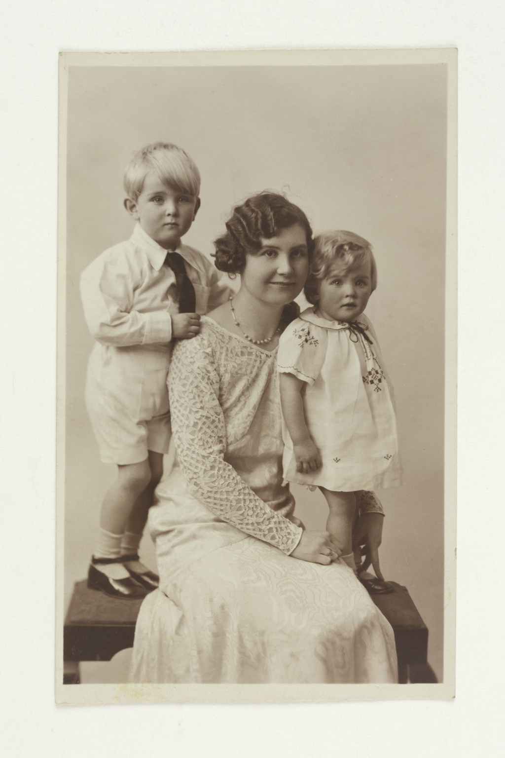 Postcard featuring portrait of Frances Way (formerly Frances Griffiths), seated with children David and Christine