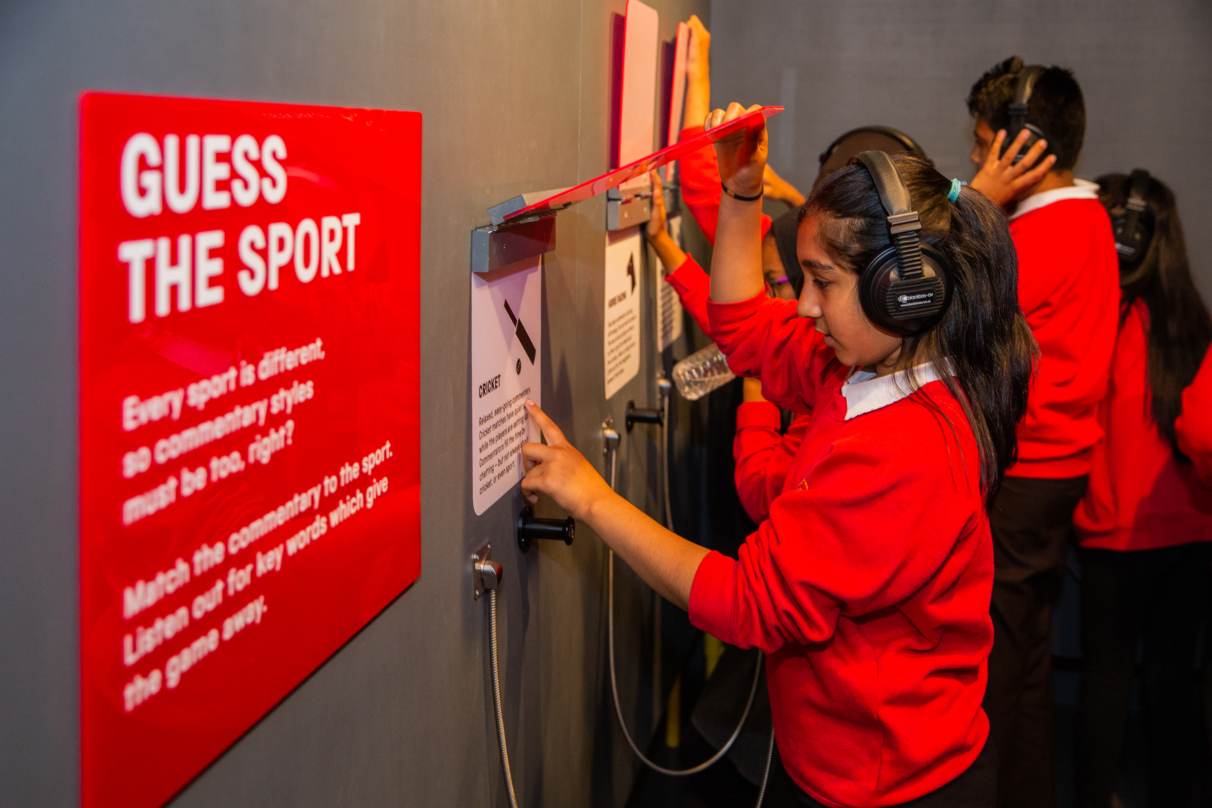 Students play with an interactive display at the Action Replay exhibition