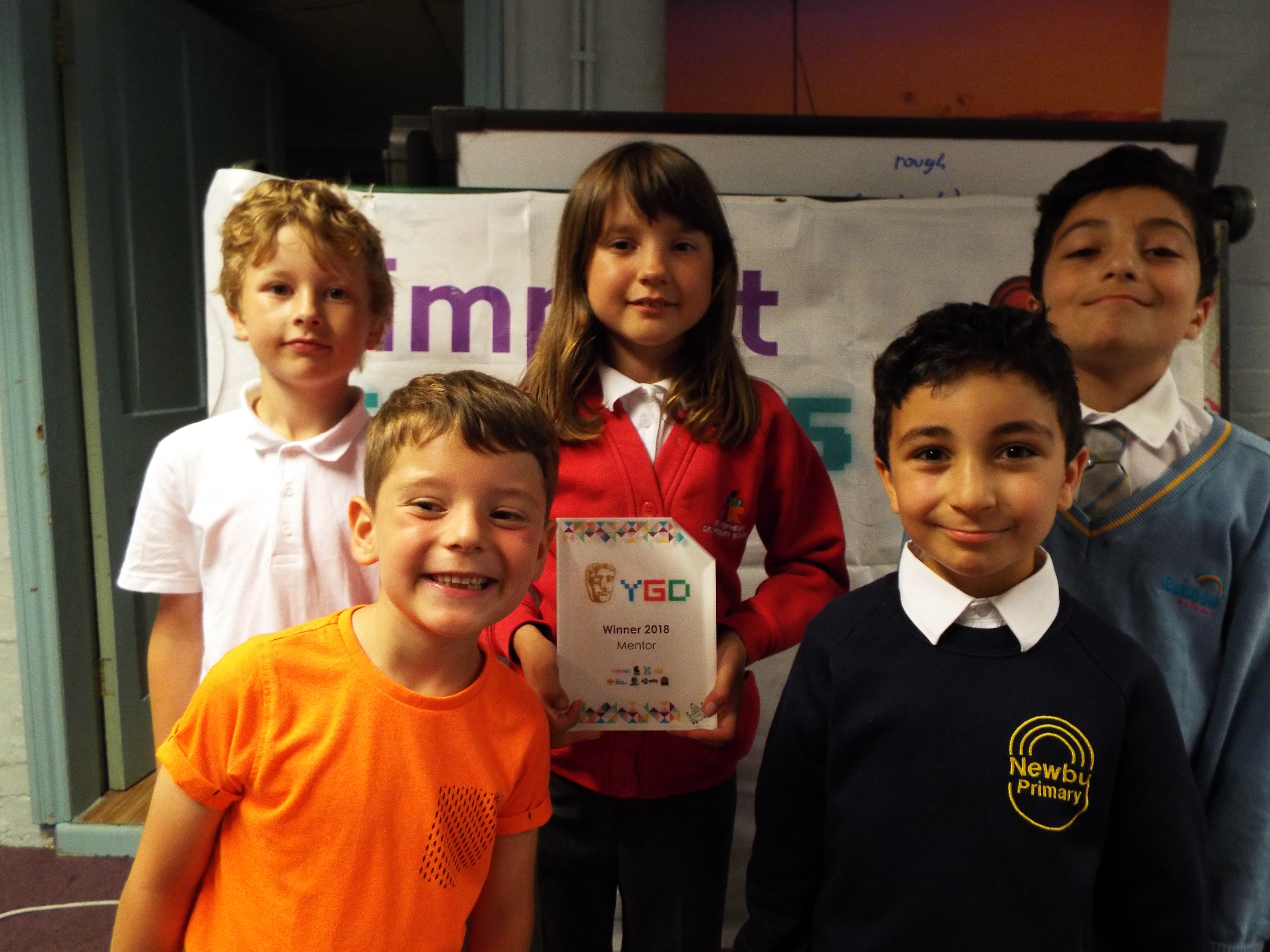 Children at Impact Gamers holding the 2018 BAFTA Young Game Designers Mentor Award