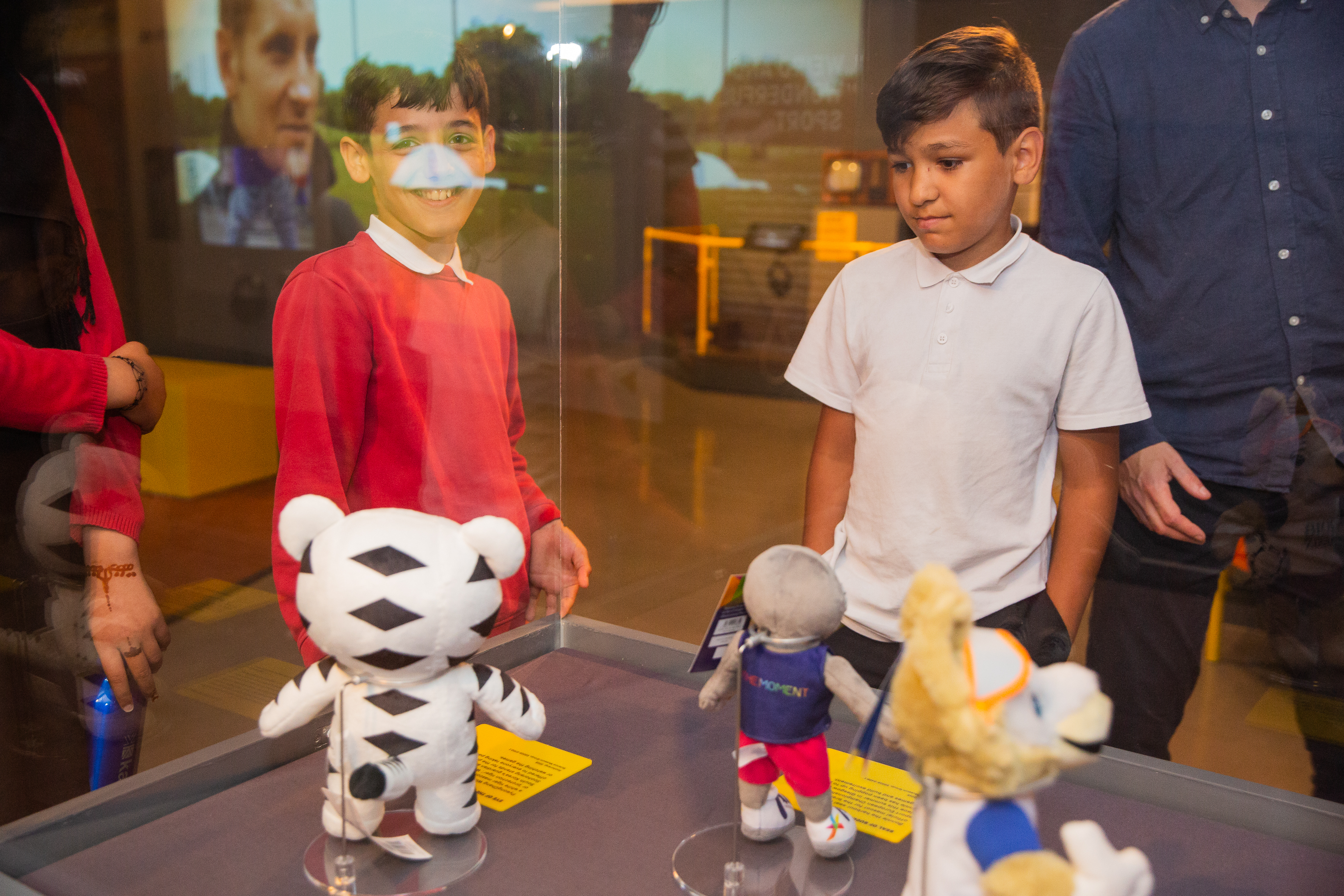 Students looking at mascots at the Action Replay exhibition