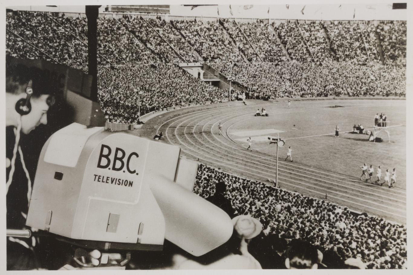 Photograph showing a CPS Emitron camera pointed toward the athletics track during the 1948 Olympics in London