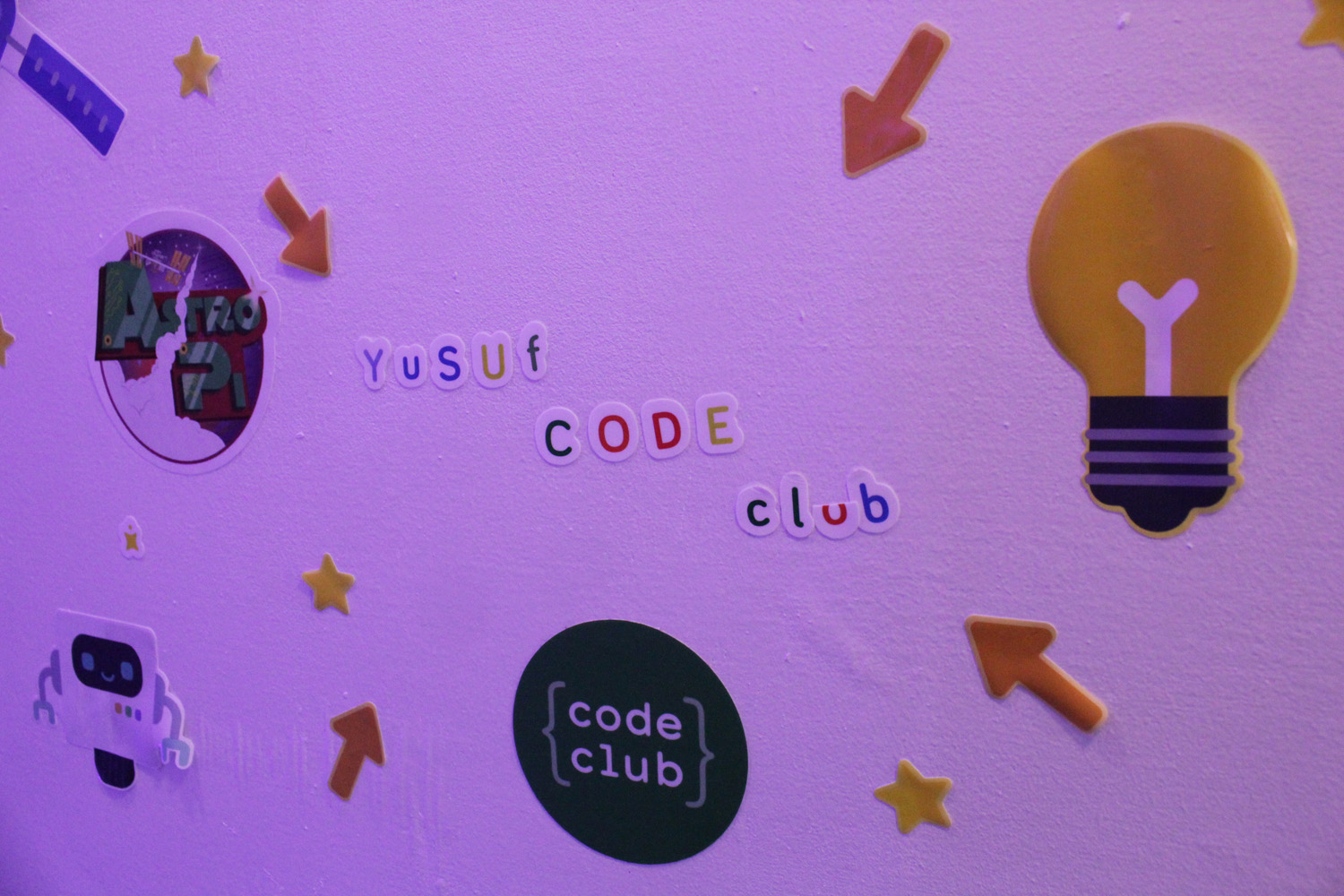 Detail of Yusuf's Dengineers den with 'Yusuf Code Club' stickers on the wall