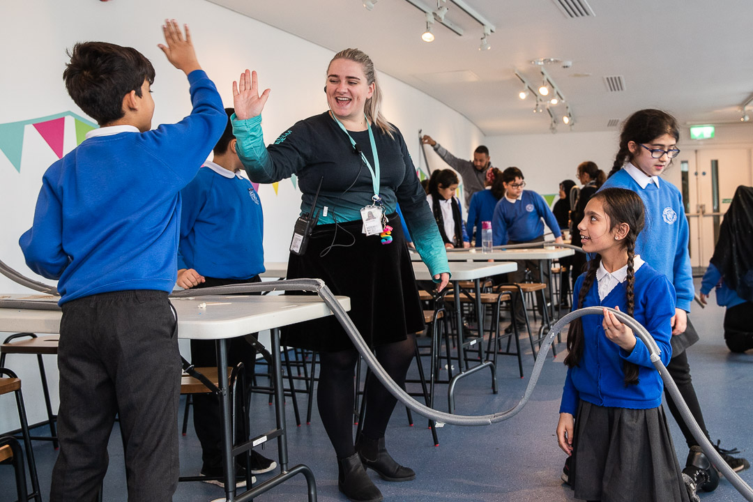 A National Science and Media Museum Explainer introduces a science activity to a group of schoolchildren
