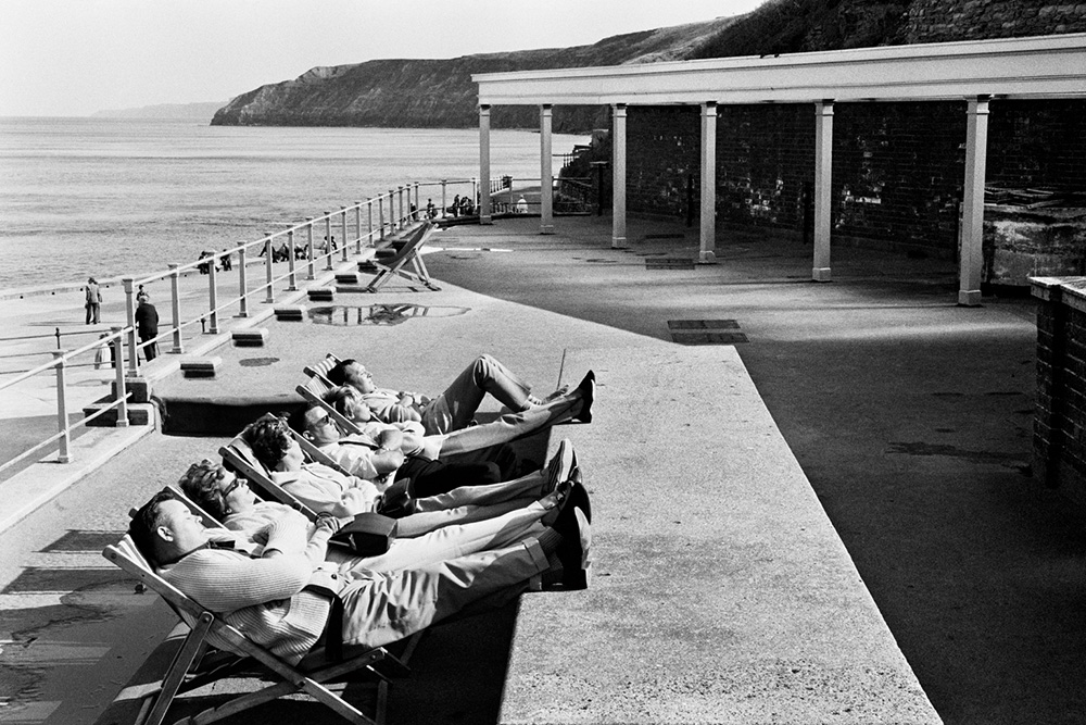 Group of people in deckchairs on Scarborough seafront