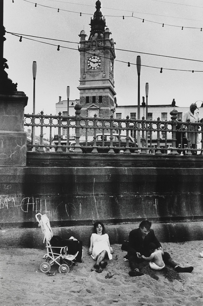 Family on Margate beach with clock tower in background