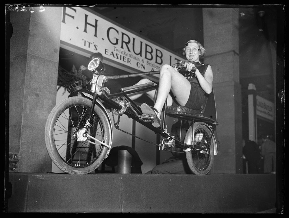 Woman sitting on a horizontal bicycle
