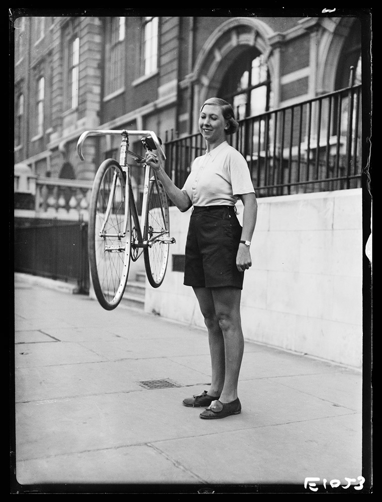 Woman holding up lightweight bicycle with one finger