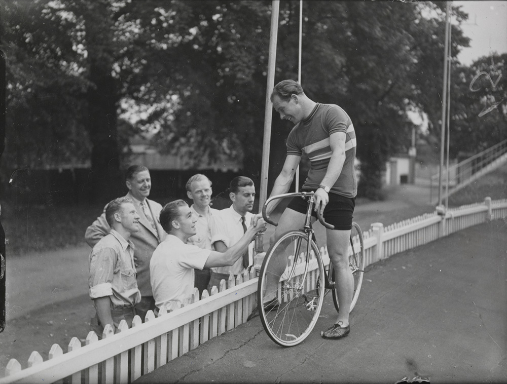 Reg Harris being greeted by some of the Danish cycle team while training at Herne Hill
