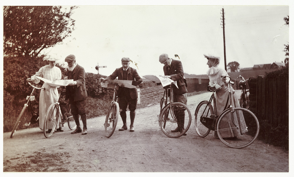 Cyclists looking at maps