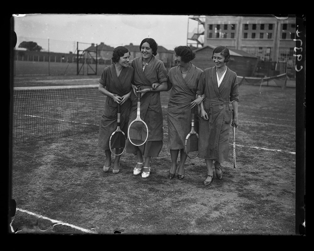 Hoover factory workers on a tennis court outside the factory building