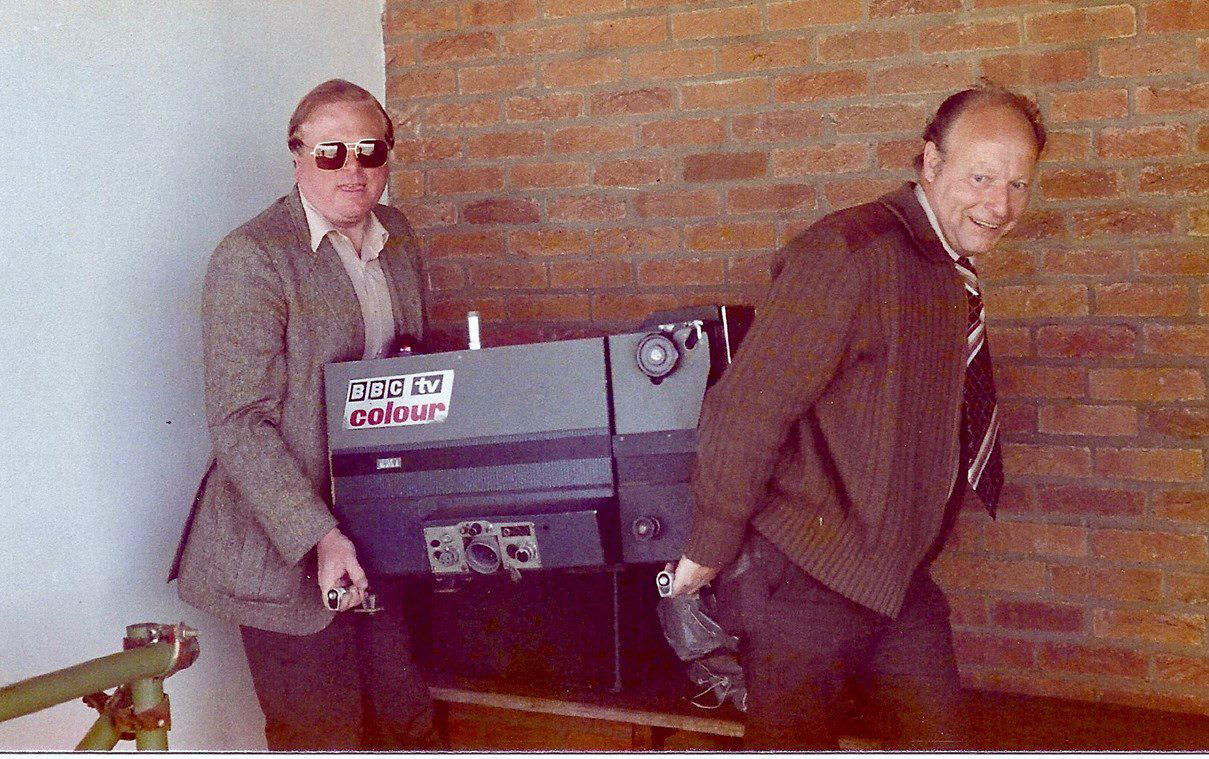 Two men carrying EMI 2001 television camera