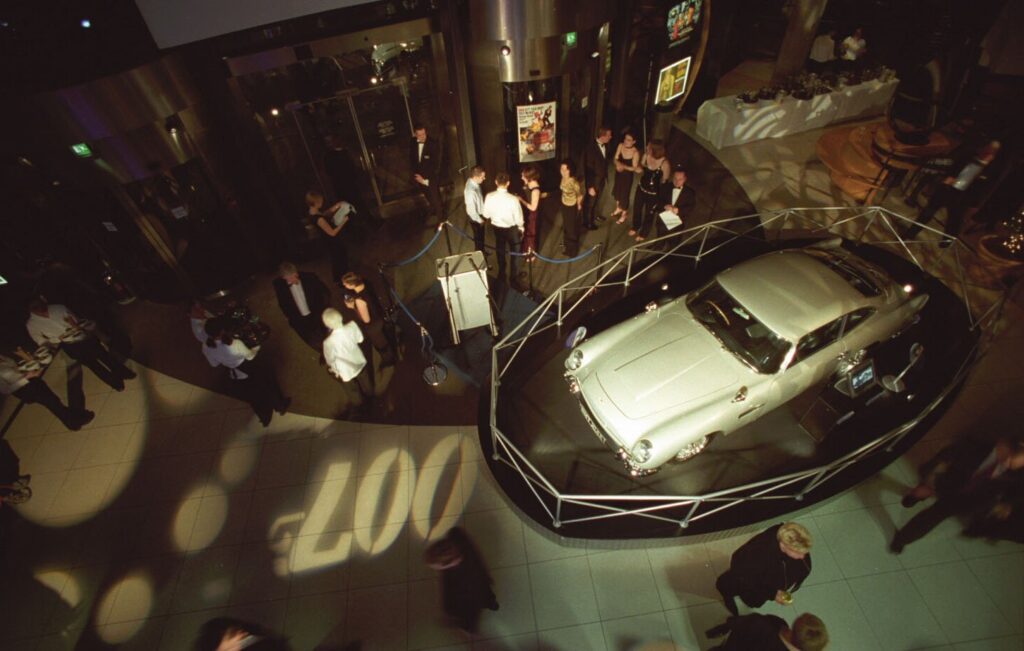 A Bond car in the museum foyer with '007' projected onto the floor