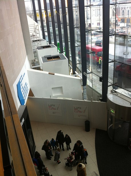An overhead view of the museum foyer, with hoardings up where the gallery was being installed.