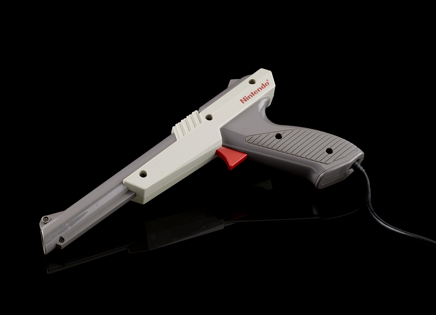 A pistol shaped game controller made of grey plastic