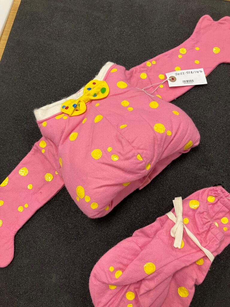 A Mr Blobby outfit on a black background