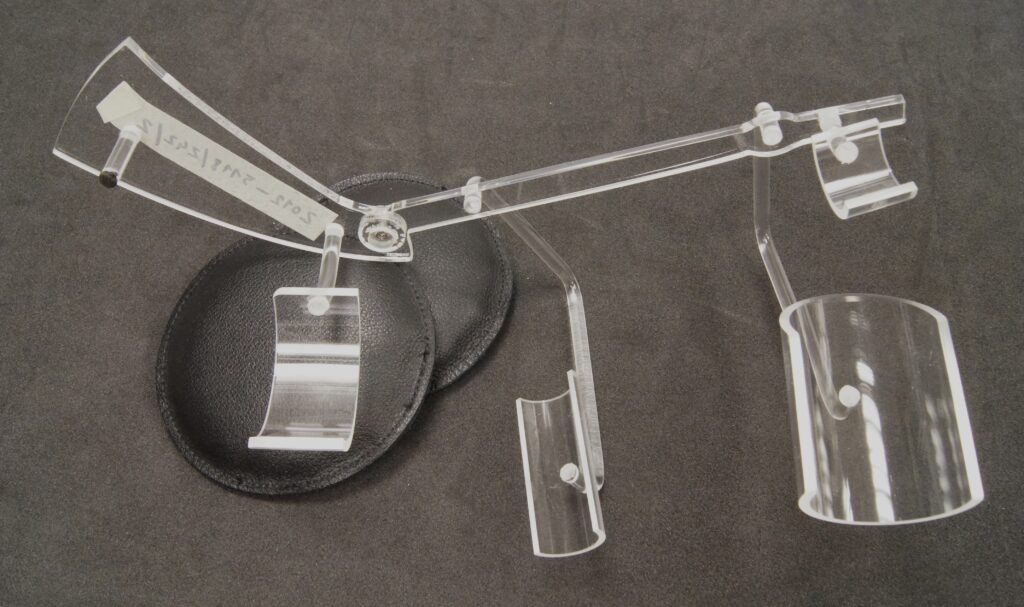 A clear perspex mount for a horn-shaped musical instrument
