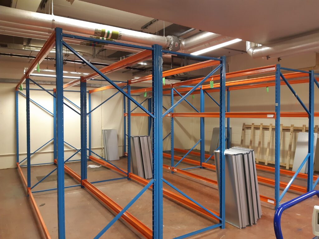 A basement storeroom with metal shelving frames