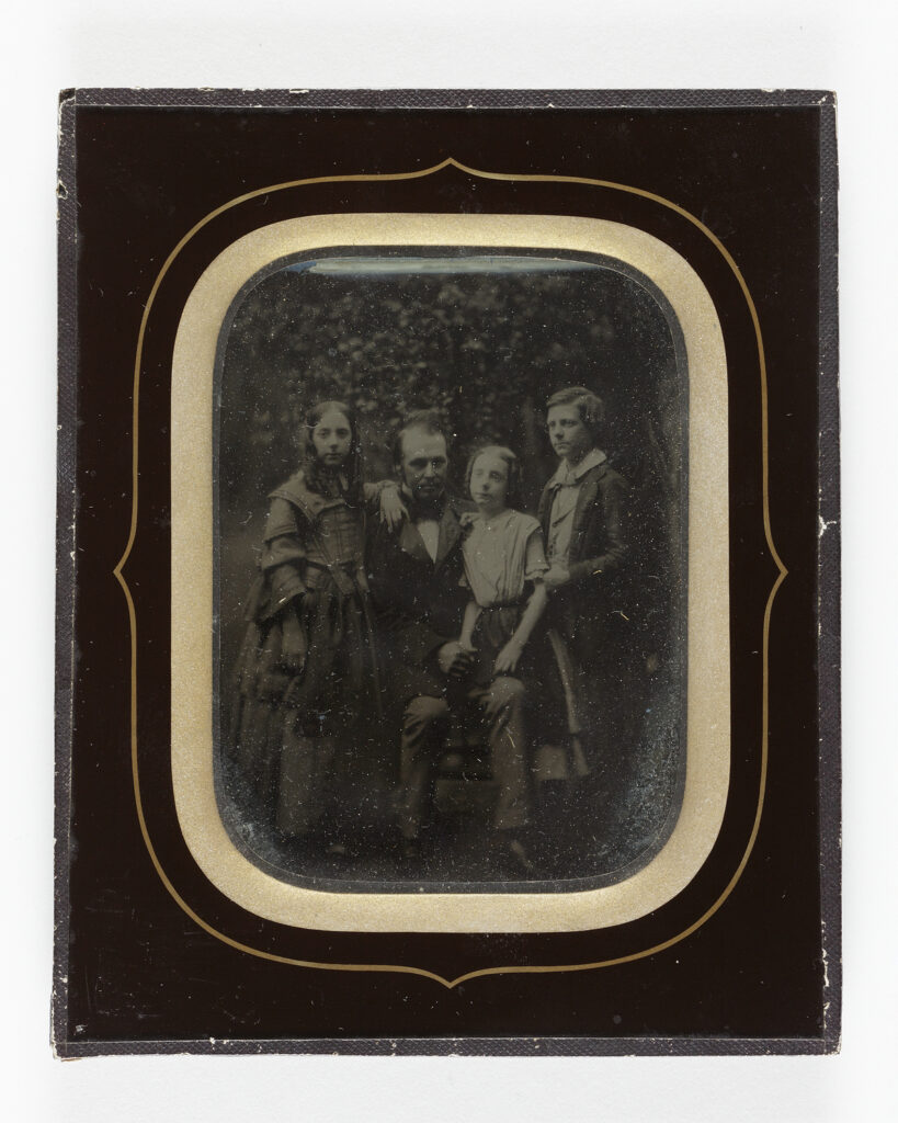 Framed photo of Jabez Hogg and three children