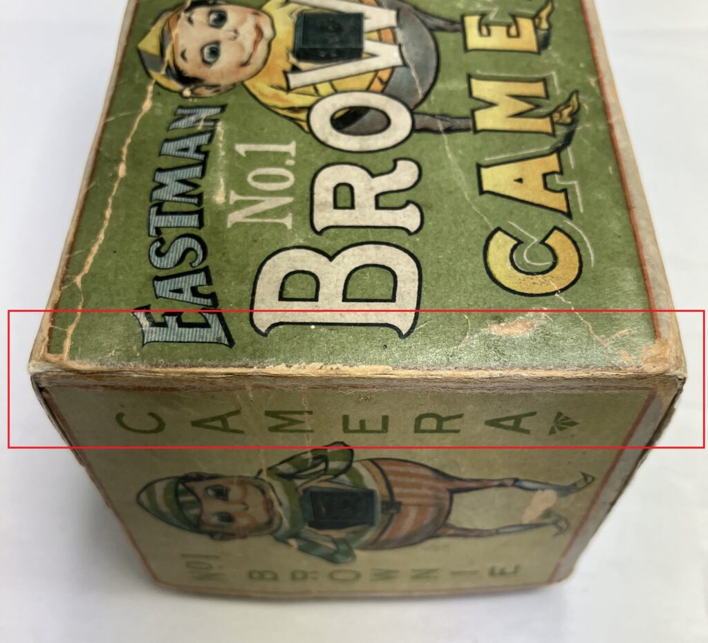 old card camera box with a red outline showing the damaged area after being treated.