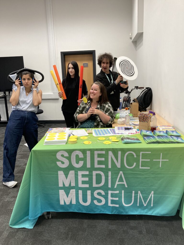 Explainer team members pose at the museum table