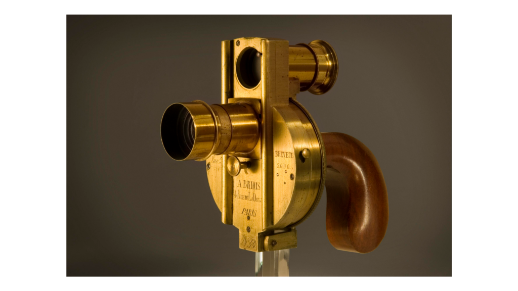 A brass-coloured camera shaped similarly to a pistol.