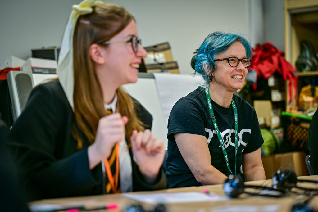 Two smiling people taking part in a workshop.