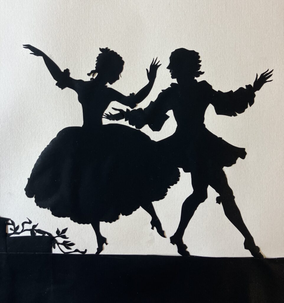 Close-up of two dancers in the paper silhouette