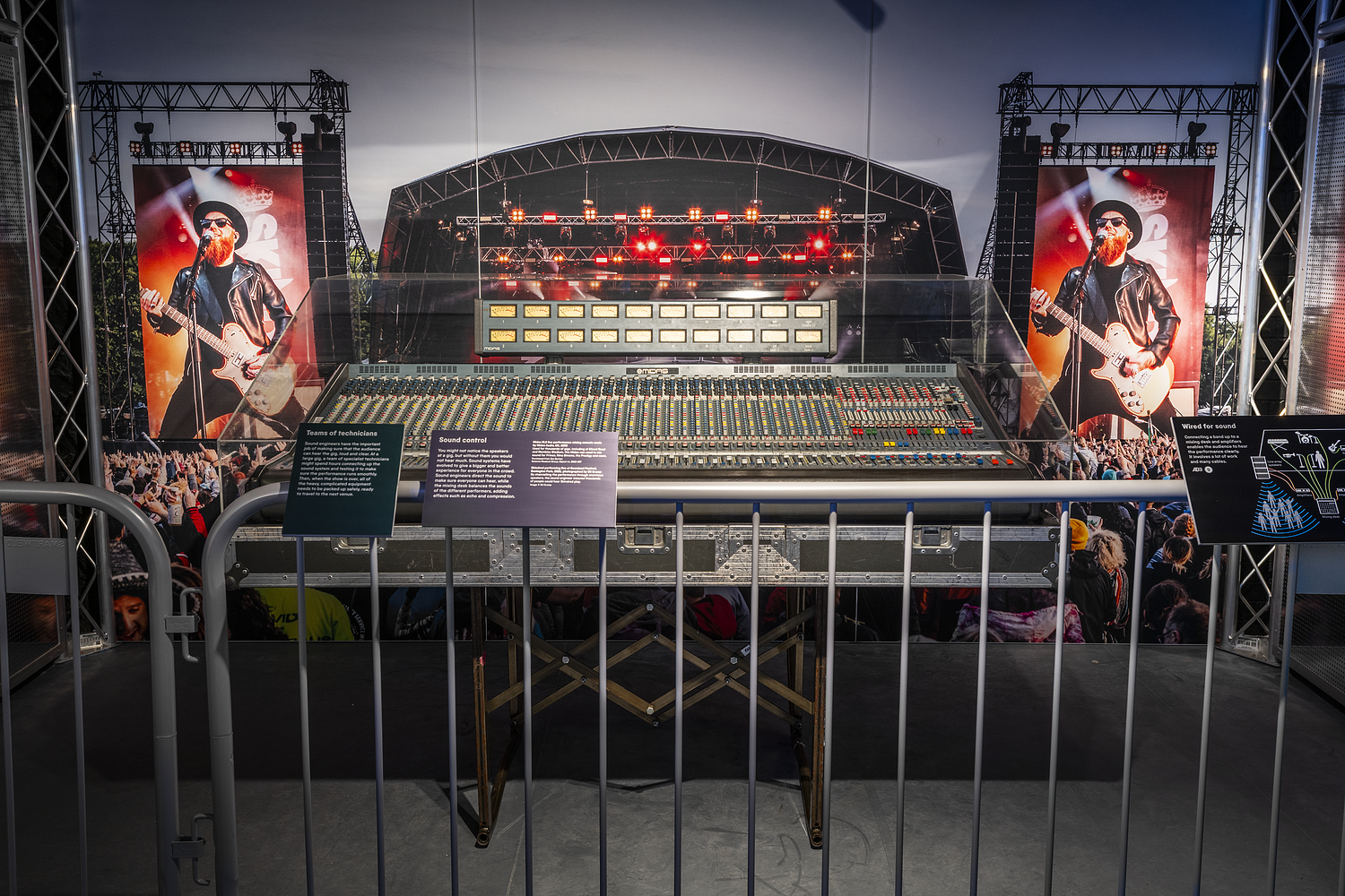 large concert sound desk displayed behind crowd barriers to give the feeling of a concert