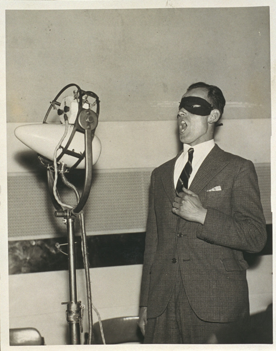A mystery singer rehearses for John Watt's One Crowded Hour, a variety radio programme broadcast by the BBC, 4 October 1934, Fox Photos © National Media Museum, Bradford / SSPL. Creative Commons BY-NC-SA