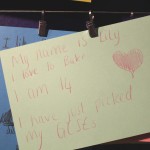 Handwritten card reading "My name is Lily, I love to bake, I am 14, I have just picked my GCSEs"