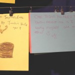 Cards written by children reading "I love jaguars, cake. By Tamzin Hector, age 9" and "One thing you need to know about me is I love being myself all the time"