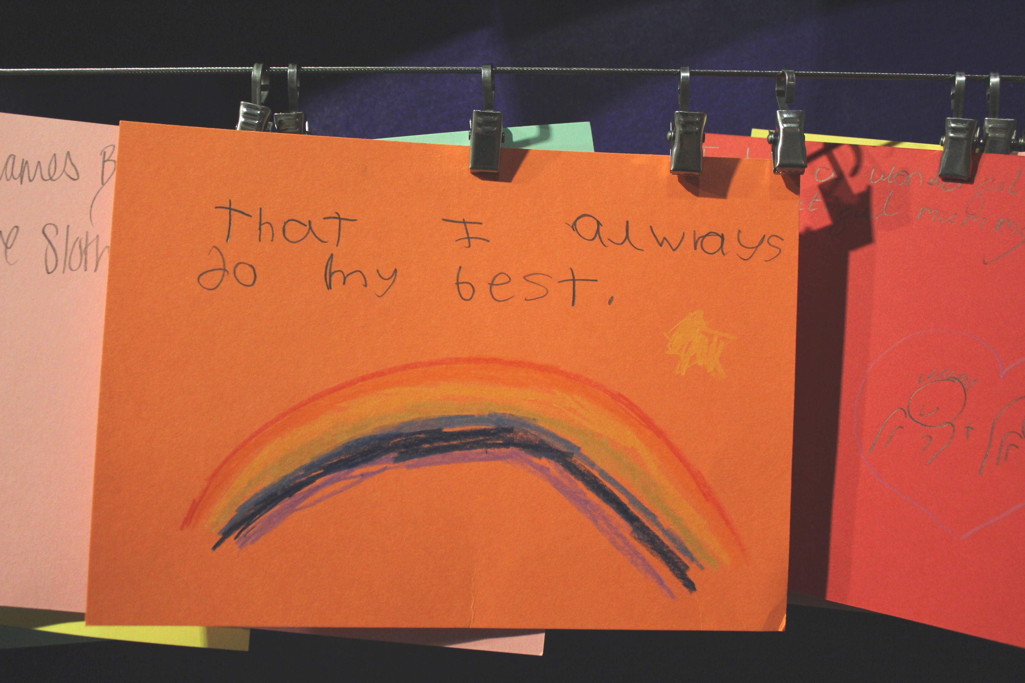 Handwritten card with a rainbow reading 