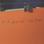 Card in child's handwriting reading "I am a kind and lovely boy"