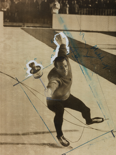 A speed skater falling forward whilst holding a flaming torch