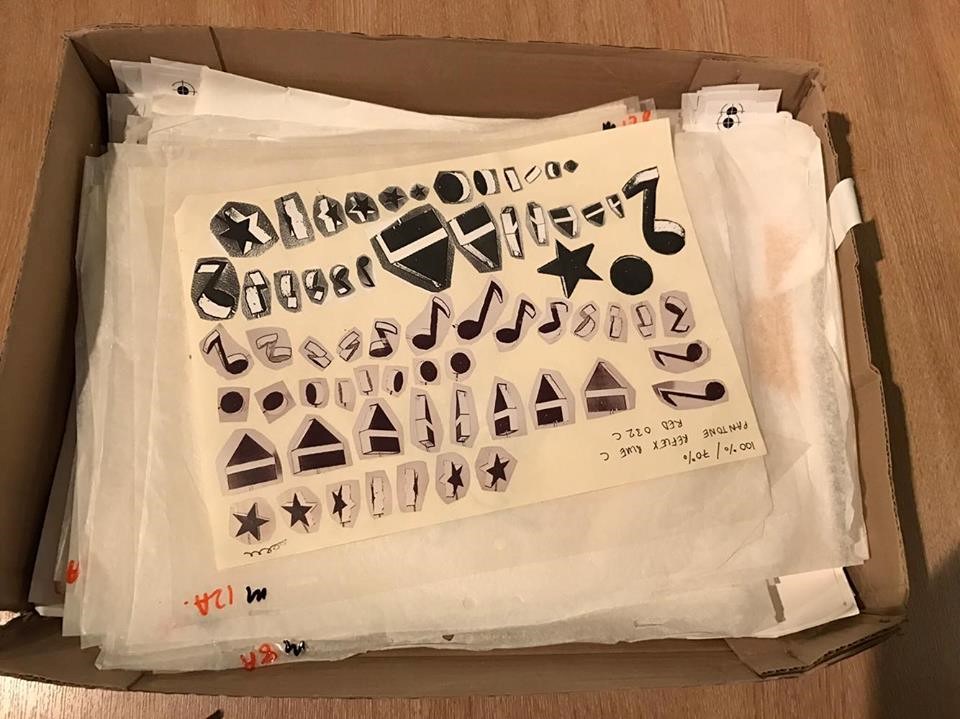 A page from the Run Wrake Archive showing a collage of various symbols including muscial notes and stars