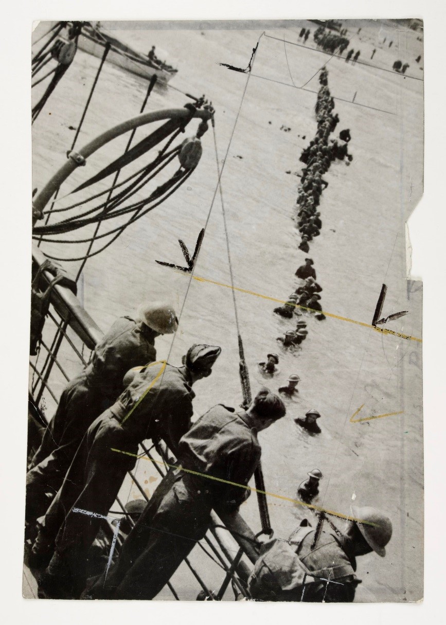 A photograph of a human chain of soldiers stretching across Dunkirk beach to a ship leaving for England
