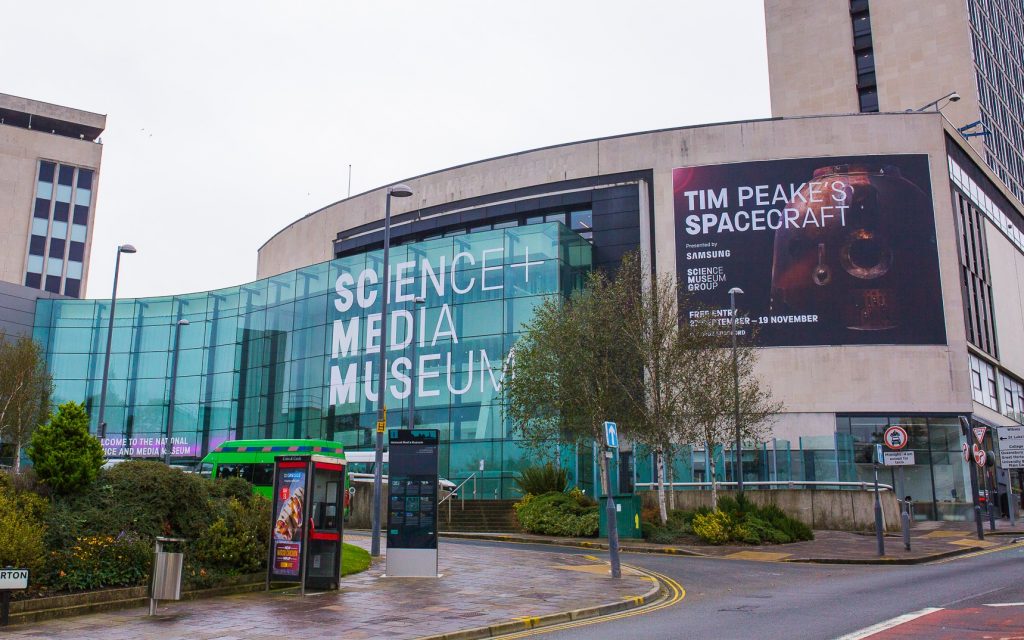 Image shows the exterior of the National Science and Media Museum in Bradford, displaying a banner for Tim Peake's Spacecraft