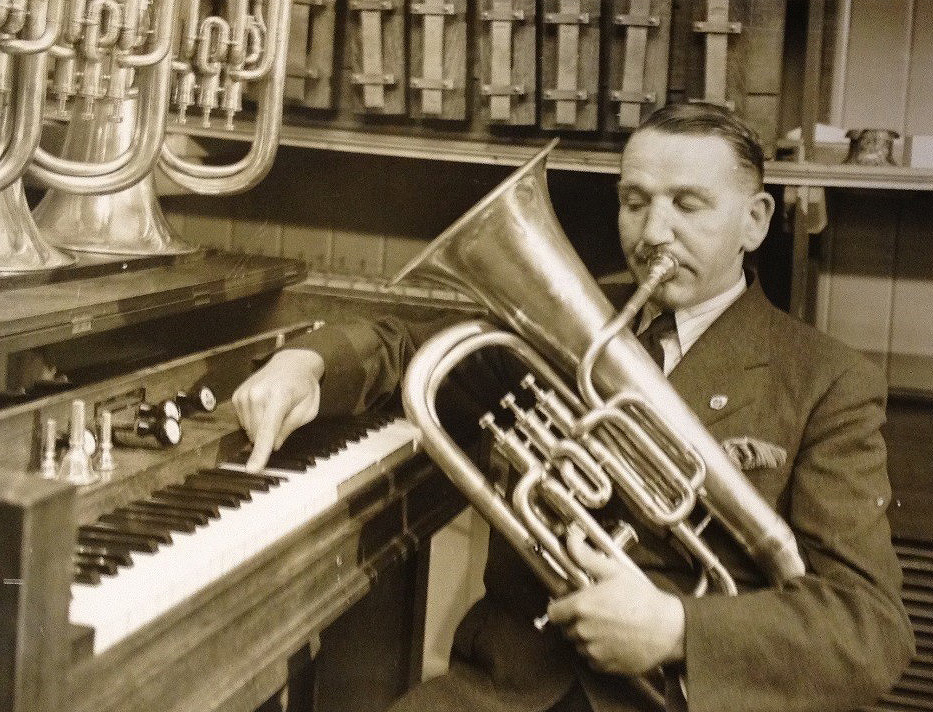 Photograph showing an expert testing a euphonium for pitch in 1939