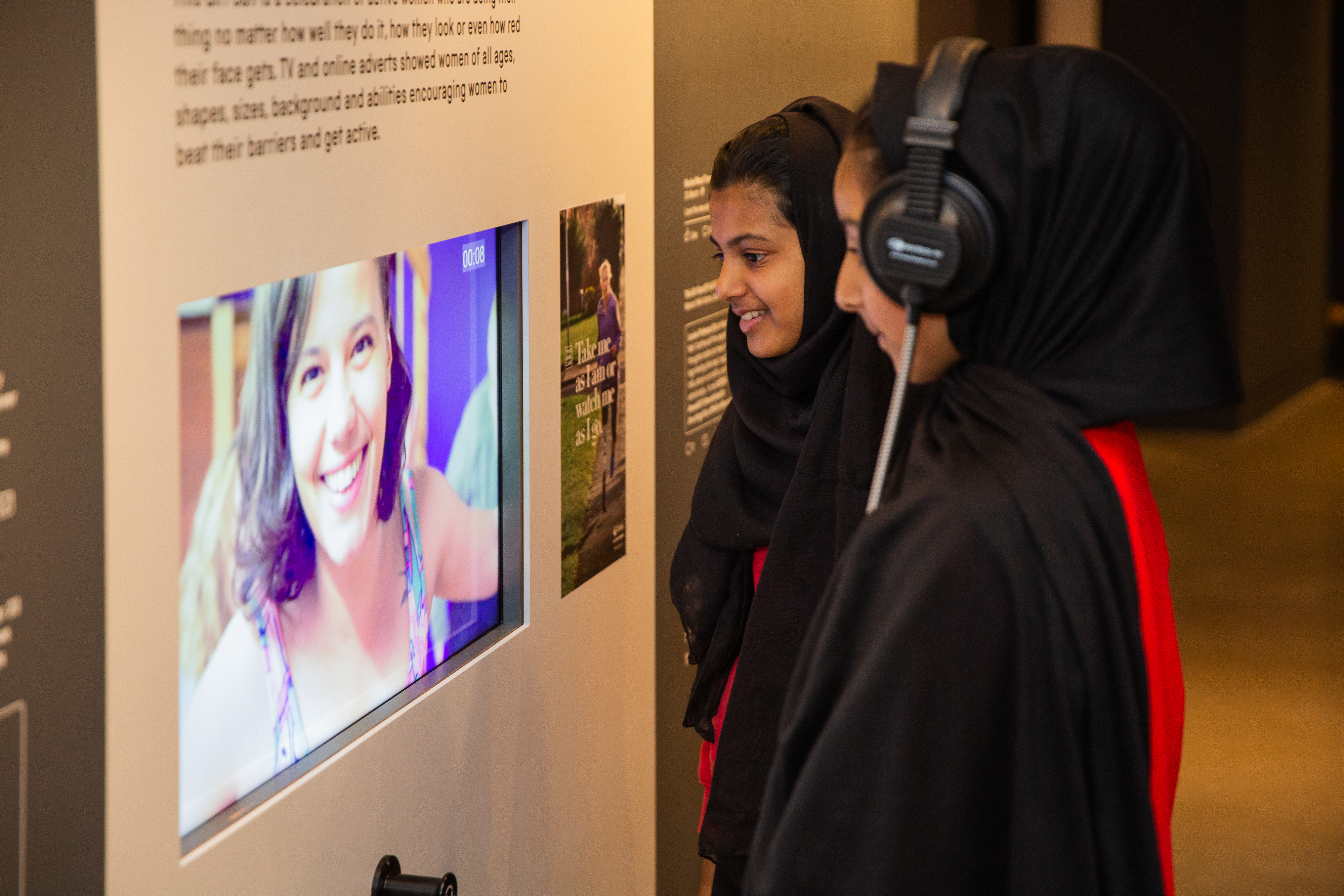 Students watch an interactive display at the Action Replay exhibition
